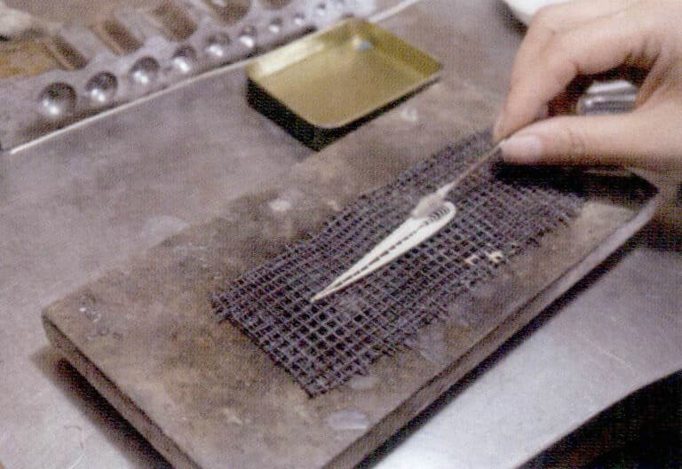 11. Coat the filament completely with borax water.