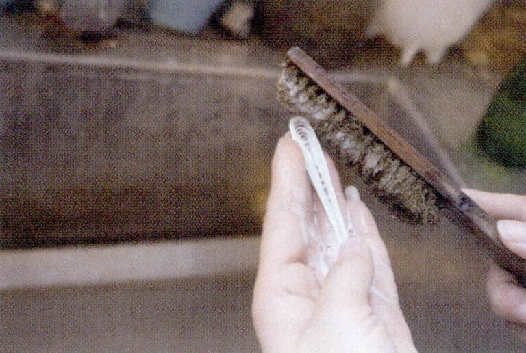 18. Cleaning earrings with a copper wire brush.