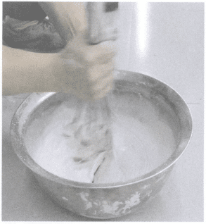 Figure 5-12 Manual mixing of investment slurry