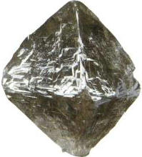 Figure 1–6 Stepped Growth Striations on an Octahedral Diamond