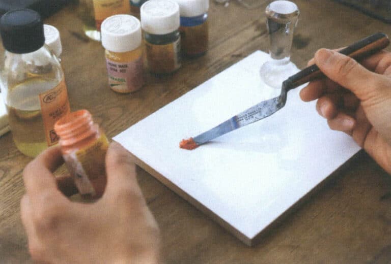 Figure 8-17 Scooping out a small amount of painted enamel glaze