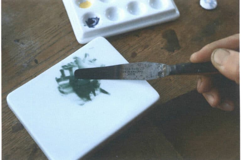 Figure 8-22 Using a palette knife to gather the dispersed glaze together