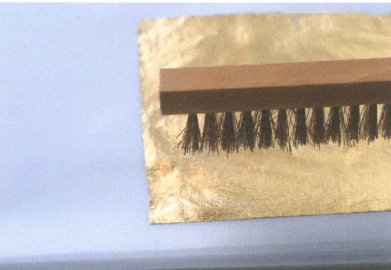 Figure 9-56 Tapping the gold leaf with a brush