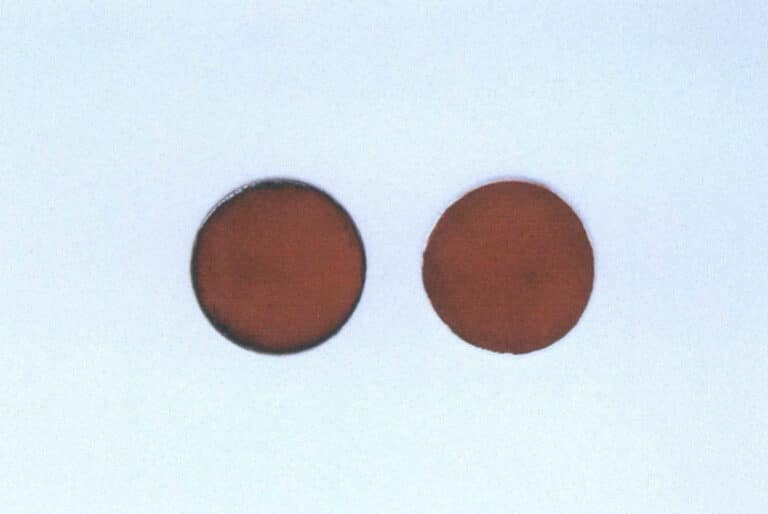 Figure 1-25 Comparison of domestically produced cloisonné coral-red opaque enamel fired on copper (left) and silver (right) substrates