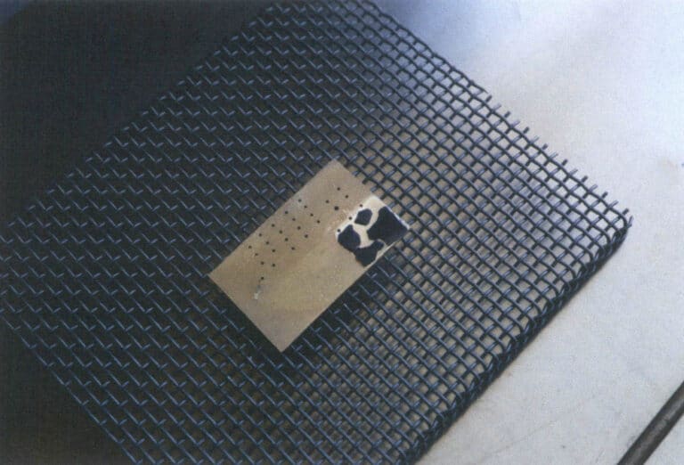 Figure 1–35 Enamel glaze spalling on a brass backing