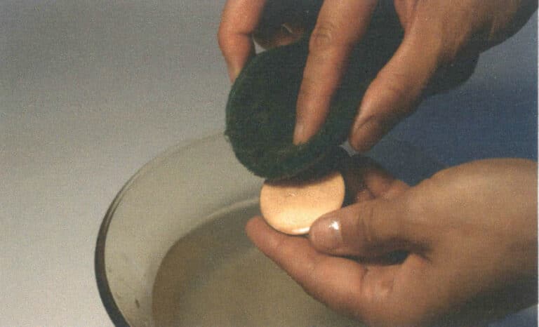Figure 2–33 Cleaning a metal surface with a scouring pad