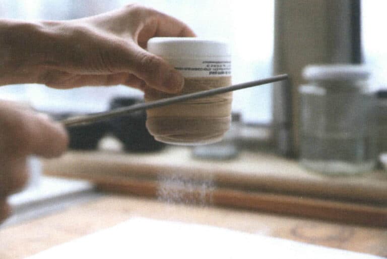 Figure 2-44 Sifting enamel with a pantyhose sieve