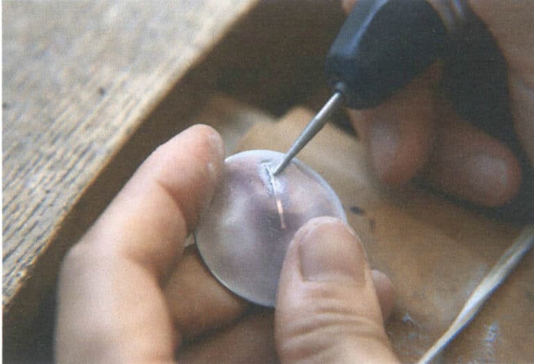 Figure 5-37 Removing metal wires embedded in the glaze with a hanging flex shaft grinder and a diamond grinding bur