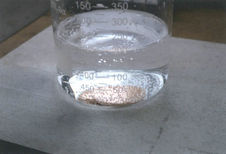 Figure 6-2 Immersing the cut copper base plate into a dilute sulfuric acid solution