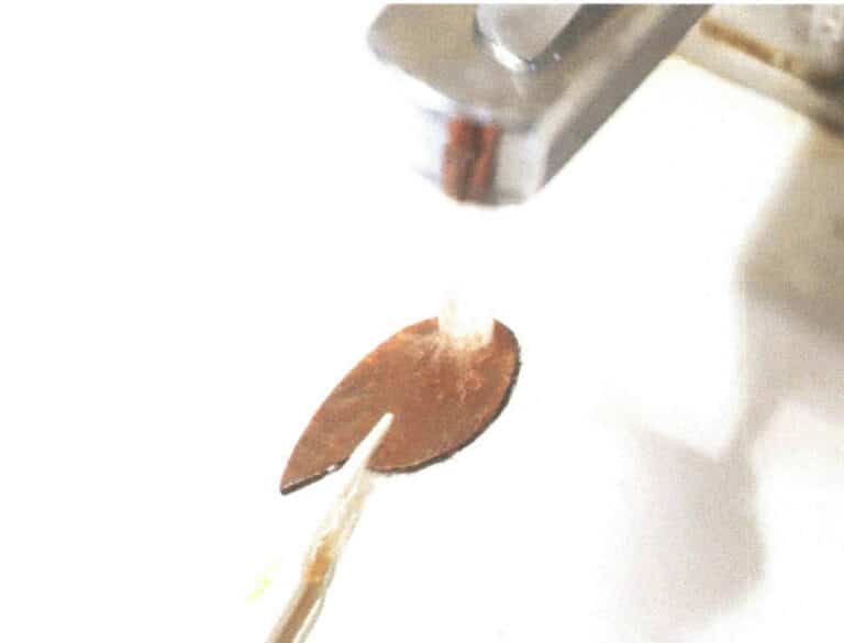 Figure 6-16 The acid-etched copper plate being rinsed with running water